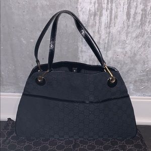 Gucci Black GG canvas with gold accents